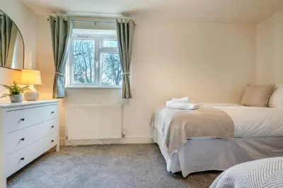 a bedroom with a bed and a dresser and a window at 5 Bed in Mitchell oc-c30790 in Mitchell