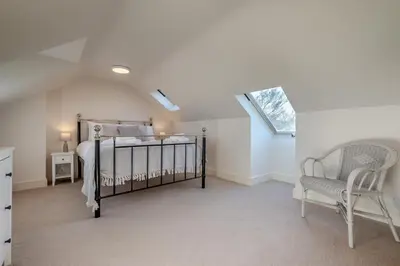 a bedroom with a bed and a chair at 5 Bed in Mitchell oc-c30790 in Mitchell