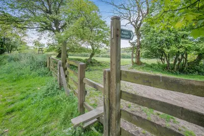 a wooden fence with a sign on top of it at 2 Bed in Advent oc-o31790 in Lanteglos