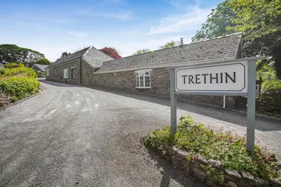 a sign in front of a stone house with a treatment sign at 2 Bed in Advent oc-o31790 in Lanteglos