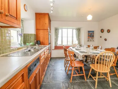 a kitchen with a table and chairs and a sink at Tremorla in Boscastle