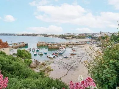 a group of boats in the water on a beach at Beach View House in Newquay
