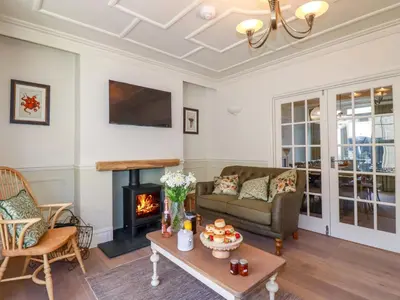 a living room with a couch and a fireplace at Beach View House in Newquay
