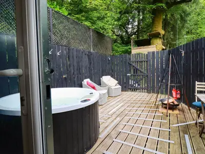 a backyard with a bath tub and a wooden deck at Foxglove in Bodmin
