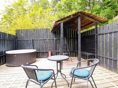 a patio with two chairs and a table and a gazebo at Bluebell in Bodmin