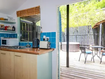 a kitchen with a counter and a patio with a table at Bluebell in Bodmin