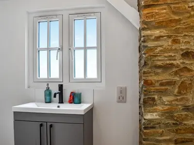 a bathroom with a sink and a window at Roseland Retreat - Uk49838 in Truro