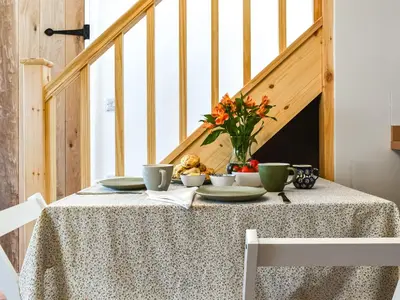 a table with a bowl of food and flowers on it at Roseland Retreat - Uk49838 in Truro