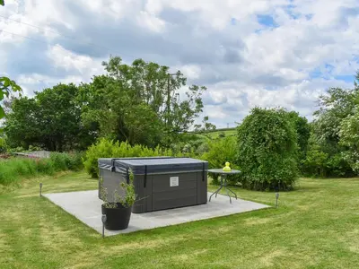 a black container with a table in a yard at Dairy Cottage - Uk49834 in Lanivet