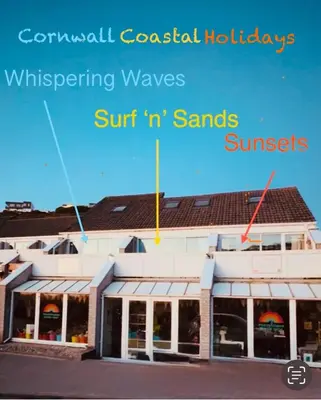 a picture of a building with the wordsconventional coastal holidaysivating waves surfin at Surf 'n' Sands in Porthtowan Beachfront Apartment in Porthtowan