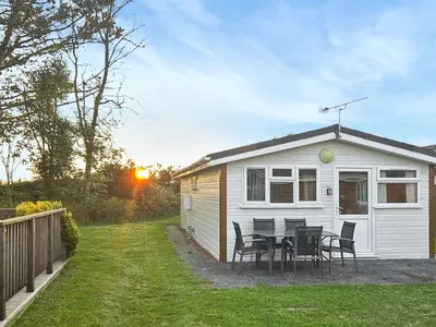 a caravan with a table and chairs in a yard at Seven Bays Retreat in Padstow