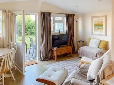 a living room with a bed and a couch at Seven Bays Retreat in Padstow