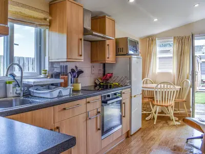 a kitchen with a sink and a refrigerator at Seven Bays Retreat in Padstow