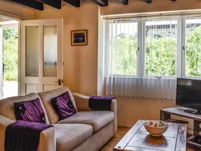 a living room with a couch and a table at The Stable - Uk49829 in Callington