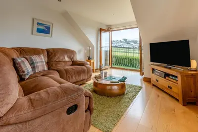 a living room with a couch and a flat screen tv at 3 Bed in Marazion oc-m30668 in Marazion