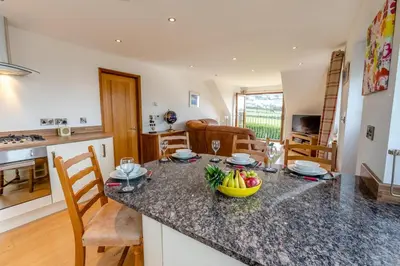 a kitchen with a table with a bowl of fruit on it at 3 Bed in Marazion oc-m30668 in Marazion