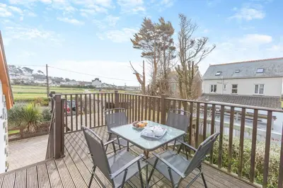 a patio with a table and chairs on a balcony at 3 Bed in Marazion oc-m30668 in Marazion