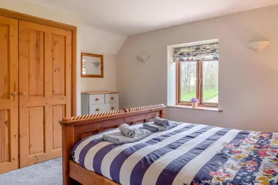 a bedroom with a bed with two teddy bears on it at 3 Bed in St. Endellion oc-o30761 in Saint Endellion