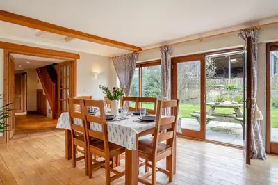 a kitchen and dining room with a table and chairs at 3 Bed in St. Endellion oc-o30761 in Saint Endellion