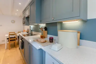 a kitchen with blue cabinets and a counter top at 2 Bed in St. Ives oc-b31979 in St Ives