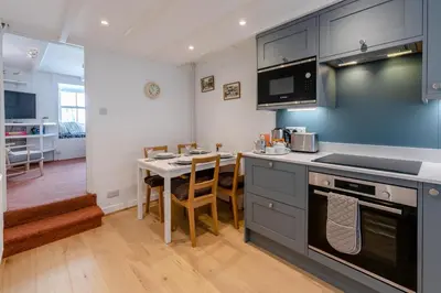 a kitchen with a table and a stove top oven at 2 Bed in St. Ives oc-b31979 in St Ives