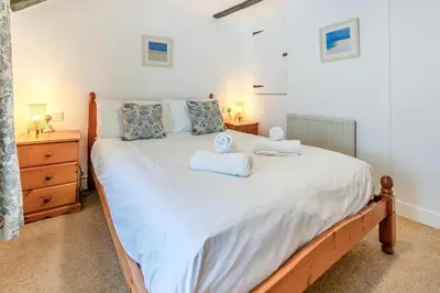 a bedroom with a large bed with two towels on it at 2 Bed in St. Ives oc-b31979 in St Ives