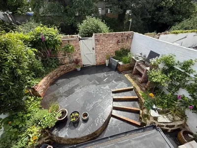 an aerial view of a garden with plants and a patio at Seaweed Suite, secluded seaside stay with garden view in Newquay