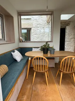 a living room with a couch and a table and chairs at Back Lane Cottage Cornwall in Gwinear