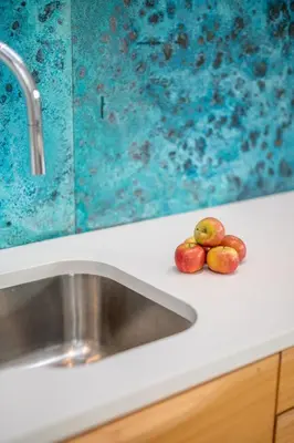 two apples sitting on a counter next to a sink at Back Lane Cottage Cornwall in Gwinear