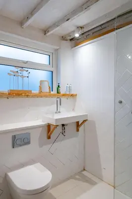 a bathroom with a toilet and a sink and a shower at Back Lane Cottage Cornwall in Gwinear