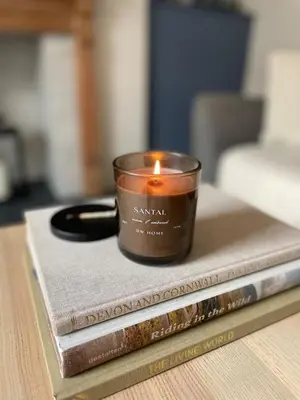 a candle sitting on top of two books at North Coast Hideaway in Redruth