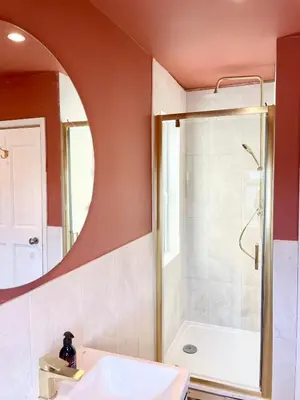 a bathroom with a sink and a shower and a mirror at North Coast Hideaway in Redruth