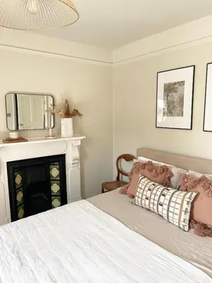 a bedroom with a bed with a fireplace and a tv at North Coast Hideaway in Redruth