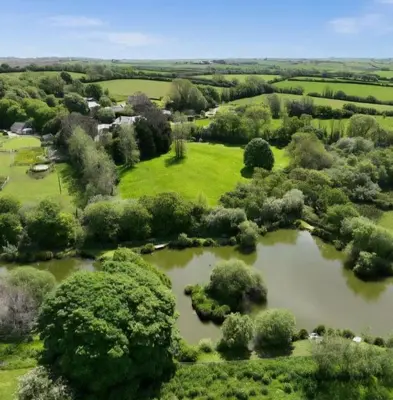 an aerial view of a park with a pond at Rural Retreat Chy Kensa a Hot Tub Haven in Grampound