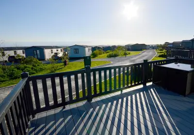 a balcony with a fence and a view of a street at Riverwood Lodge, Padstow in Padstow