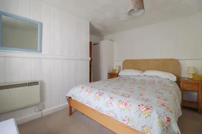 a bedroom with a bed and a flat screen tv at Trevean in Bude