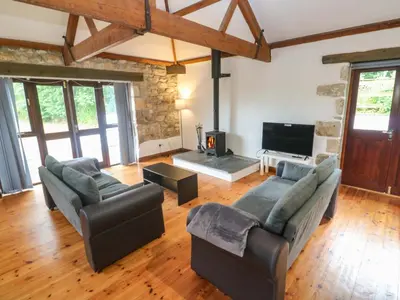 a living room with two couches and a tv at The Shippen in Penzance