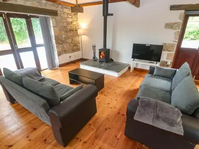 a living room with two couches and a tv at The Shippen in Penzance
