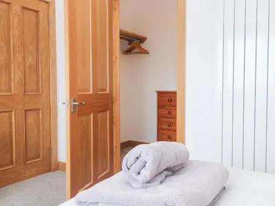 a room with a bed with a towel on it at Swallows Nest in St Ives