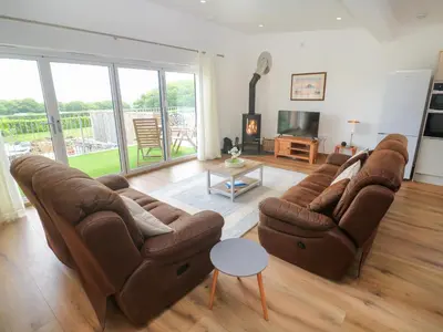 a living room with two couches and a television at Swallows Nest in St Ives