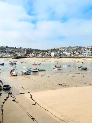 a group of boats in the water on the beach at Mermaid Apartment, A Colourful Coastal Escape By The Sea, Child Friendly in St Ives