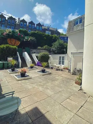 a patio with a bunch of chairs and plants at Lisas Beach Pad, A Charming Coastal Retreat with Parking in St Ives