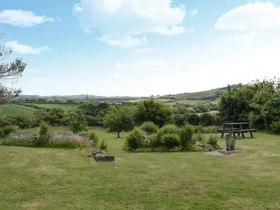 a park with a picnic table in the middle of a field at Hosta House - Uk49872 in Lanivet