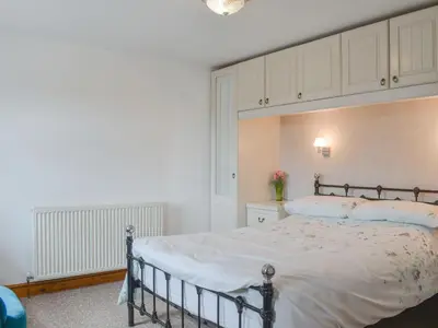 a bedroom with a large bed with a canopy at Hosta House - Uk49872 in Lanivet