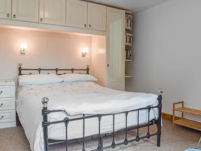 a bedroom with a bed and a book shelf at Hosta House - Uk49872 in Lanivet