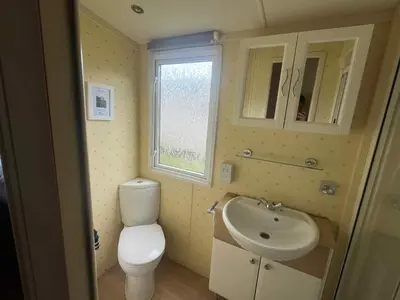 a small bathroom with a toilet and a sink at Pet Friendly Static in Carnbrea Station