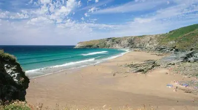 a beach with people on the sand and the ocean at 4 Bed in St. Endellion oc-t30725 in Saint Endellion