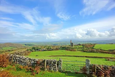 a field with a fence and a stone wall at 4 Bed in St. Endellion oc-t30725 in Saint Endellion