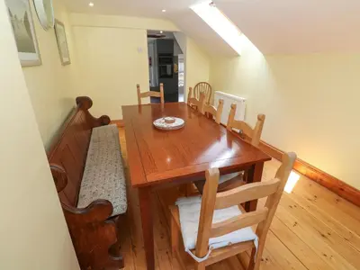 a dining room with a wooden table and chairs at The Cottage in St Ives