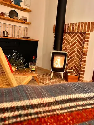 a living room with a fireplace and a television at Treth Newquay in Newquay